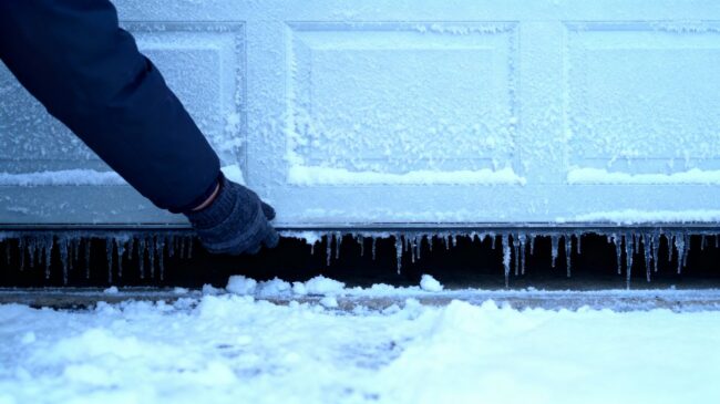 Winter garage door with icicles and snow.